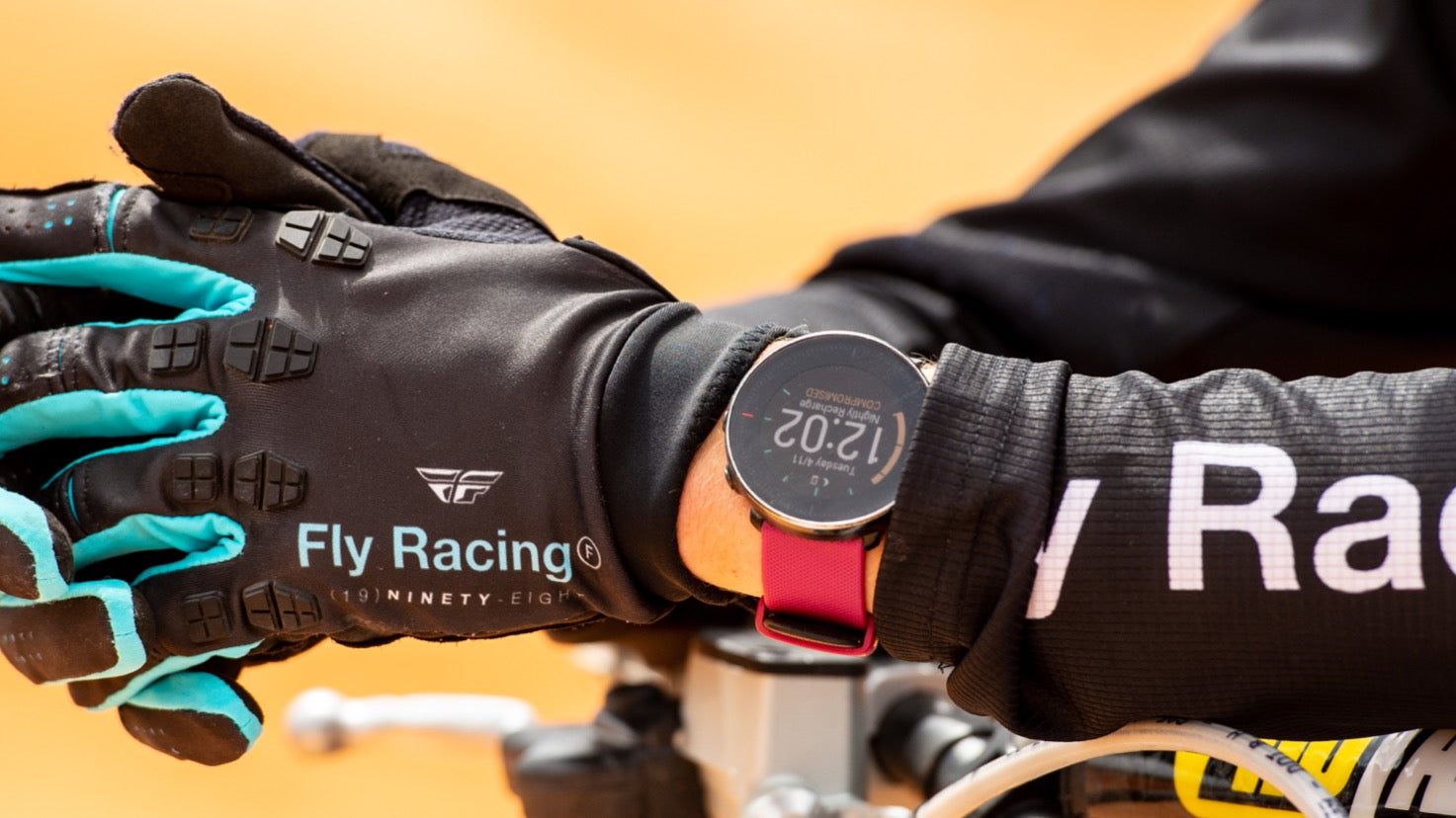 Close-up of FLY Racing gloves on eMoto handlebars