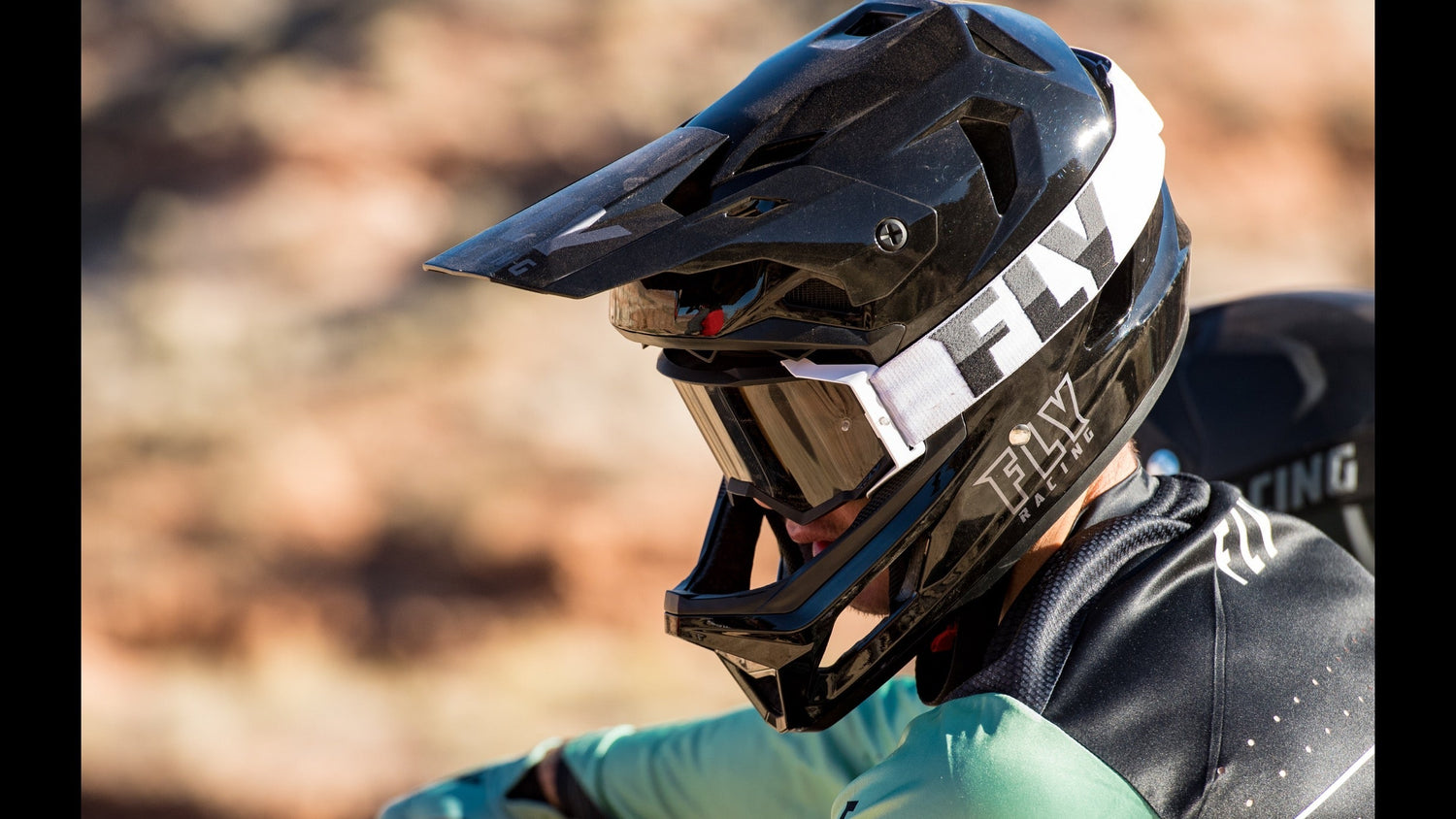 Black FLY Racing full-face helmet and goggles for electric dirt bike riding